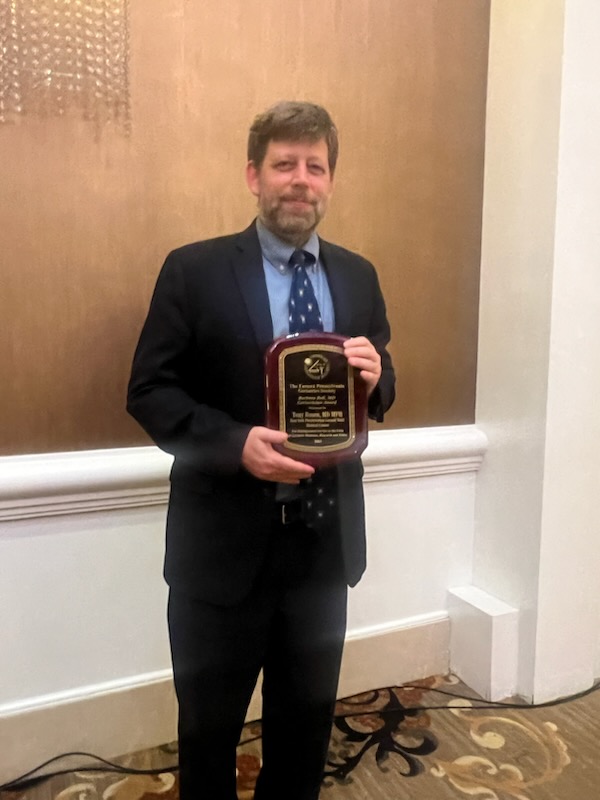 Tony rosen holding barbara bell award
